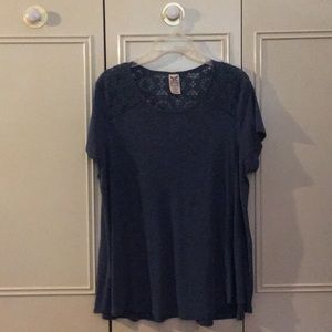 Blue flowy top with a lace pattern on the back.